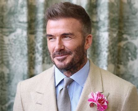 Brooklyn Beckham net worth and father David Beckham at a public event

